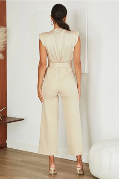 nude jumpsuit with a back zipper closure.